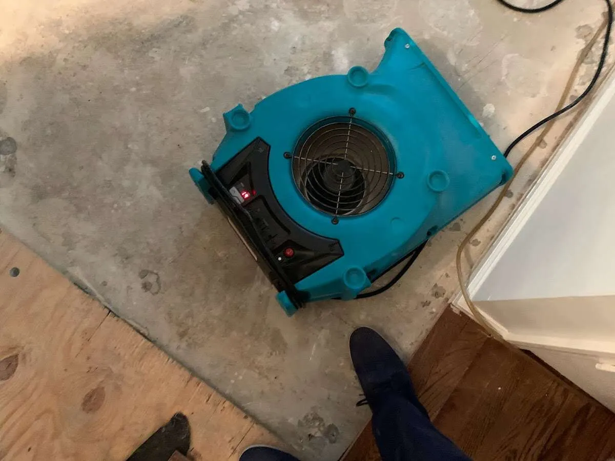 Air mover drying subfloor during Leak Detection & Repair in Heath